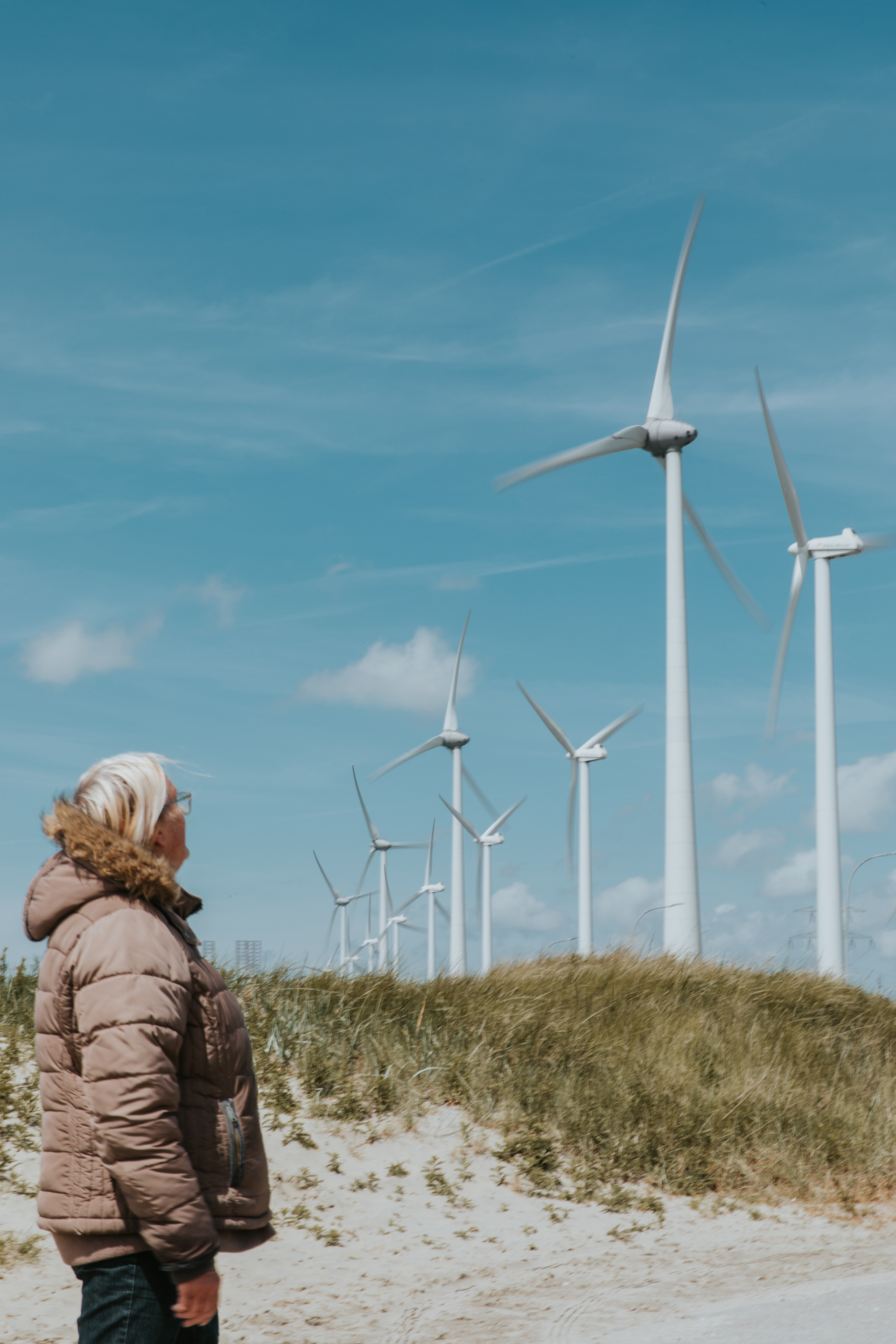 Picture of a lady and some wind turbines in North Sea Port’s Vlissingen sub-area.