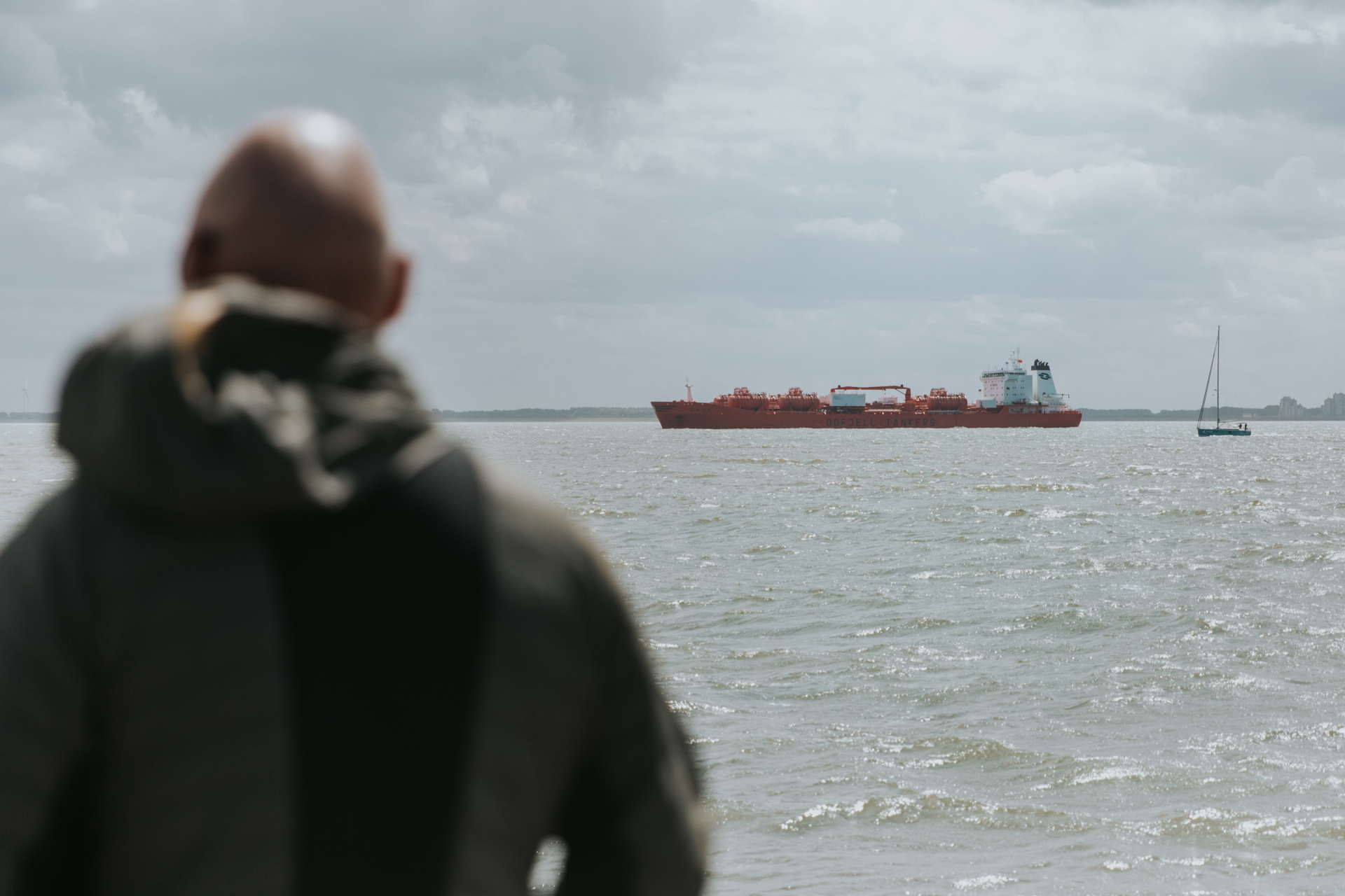 Picture of man and a seagoing vessel in the Vlissingen port area of North Sea Port.