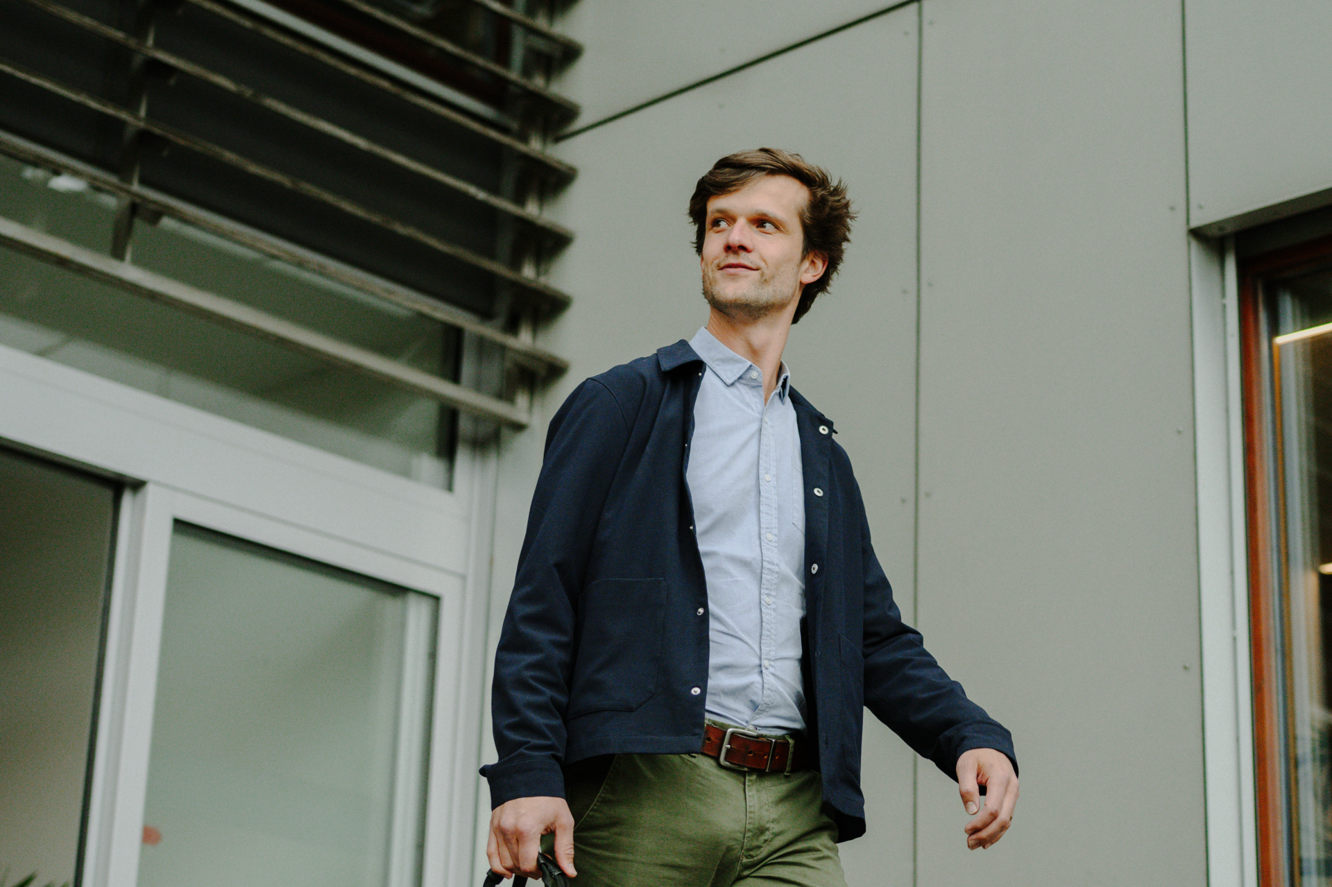 A picture of a man walking outside of the Office.